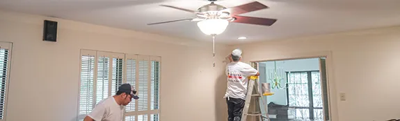 workers painting interior of a home